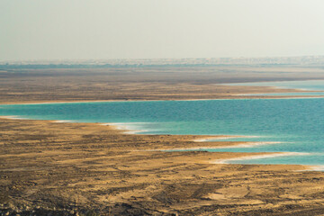 Dead sea, a national landmark in Jordan. blue water and sandy beach. High quality photo