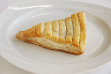 Isolated Apple turnover, croissant, cake. pastry, bakery on the white plate. White background. Top view. Close-up. Copy space