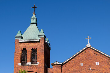 Fototapeta na wymiar A catholic church bell tower on a blue sky