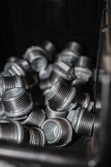 hydraulic fittings made of galvanized steel in boxes (selective focus, blur)