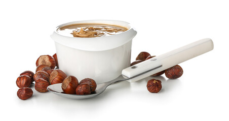 Bowl of delicious hazelnut butter and nuts on white background