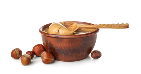 Bowl of tasty hazelnut butter on white background