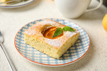 Plate with piece of tasty apricot pie on light background, closeup