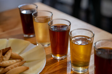 Tasting of different sweet wines from wooden barrels owith cheese n old bodega in central part of Malaga, Andalusia, Spain