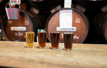 Tasting of different sweet wines from wooden barrels on old bodega in central part of Malaga,...