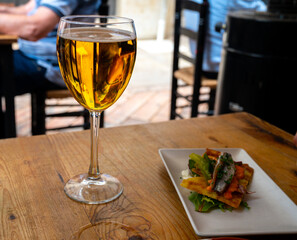 Fresh draught lager beer is glass served in outdoor cafe