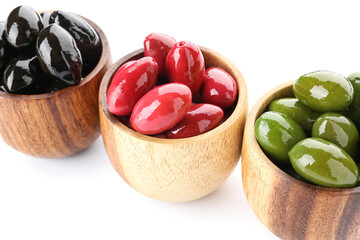 Bowls with different kinds of tasty olives on white background, closeup