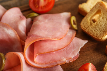 Slices of delicious ham on wooden background, closeup