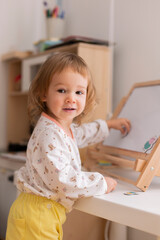 Little girl playing with magnets