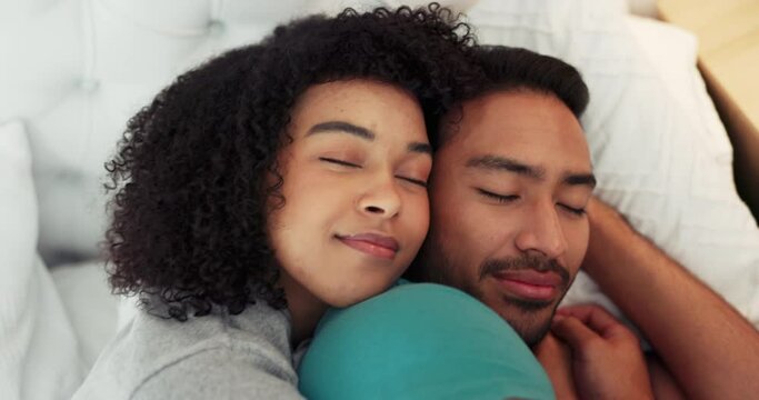 Love, hug and relax couple sleep in bed together cuddle, happy and smile while at peace dreaming in home bedroom. Romantic young man and woman bond while sleeping, rest and taking cozy comfort break