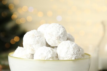 Fototapeta na wymiar Tasty snowball cookies in light bowl, closeup, Christmas treat