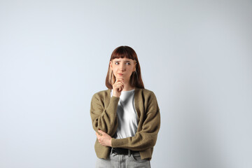 Portrait of confused young girl on white background