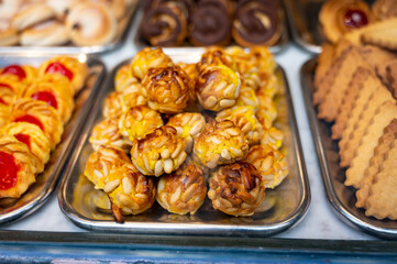 Variety of cookies and cakes on display in artisanal bakery in San Sebastian city, Basque Country, Spain