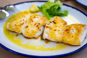 Grilled fillet of white codfish served in fish restaurant in San Sebastian, Basque Country, Spain