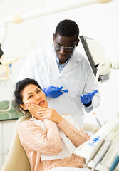 Woman with toothache sitting in chair at dentist appointment