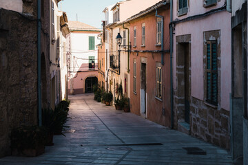 Narrow street with colorful houses in old town, Alcudia, Mallorca, Spain.