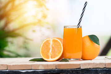 glass of fresh orange juice with fresh fruits on wooden table, high Vitamin C, orange drink, nature background