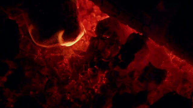 Tongues of flame. Smoldering coal, fiery background red flame burns out. Close up.