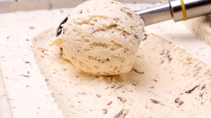 Close-up of ice cream, cookies and cream using a popsicle scoop.