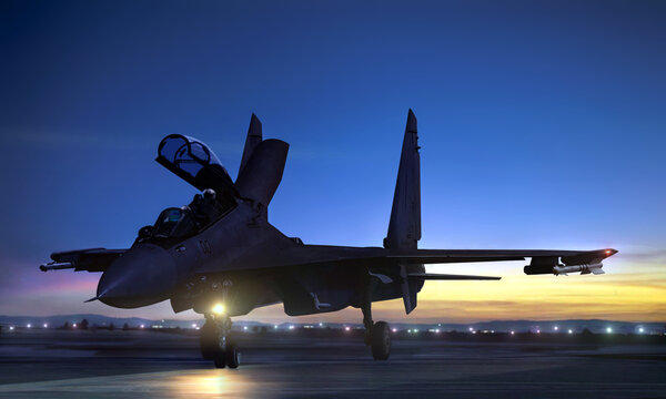 Supersonic fighter jet on air force base airfield getting ready to take off at sunset
