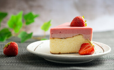 Piece of strawberry cheesecake with jelly and fresh strawberries