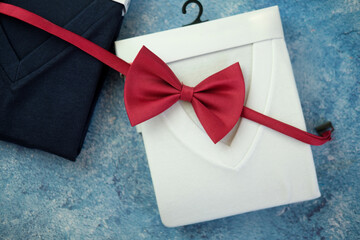 Perfectly folded v neck t-shirts and red bow tie. Top view
