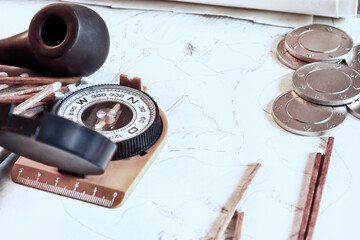 Fototapeta premium Traveler and treasure hunter accessories, map, smoking pipe, pirates coins. Retro fantasy and adventures backgrounds