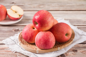 Red ripe apples on on wooden board background