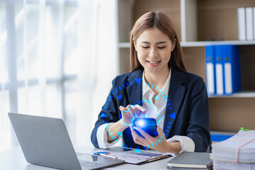 Young Asian businesswoman working in accounting Finance with using smartphones and laptops with...