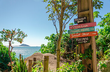 colored signs indicating the direction of the beaches