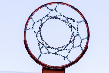 Fototapeta na wymiar Basketball hoop on a sports field against a blue sky