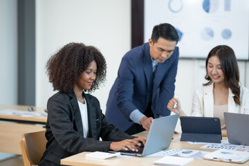 Group of young Asian businesspeople brainstorming meeting to discuss planning strategies new business development working on a new startup project in the office.