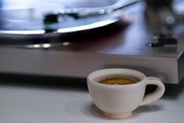 A Cup of Espresso Shot Coffee with a blur background of record turntable