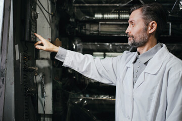 Engineer working with machines at polymer factory