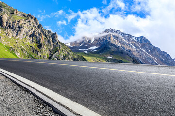 Asphalt road and mountain nature scenery under blue sky. Road and mountain background.