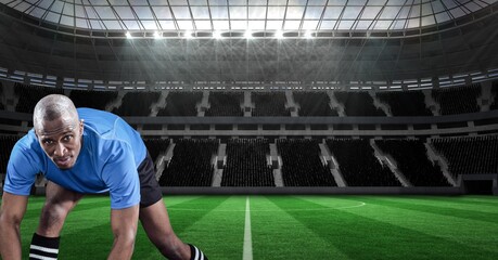 Composition of male rugby player over sports stadium