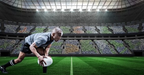 Composition of male rugby player holding rugby ball over sports stadium