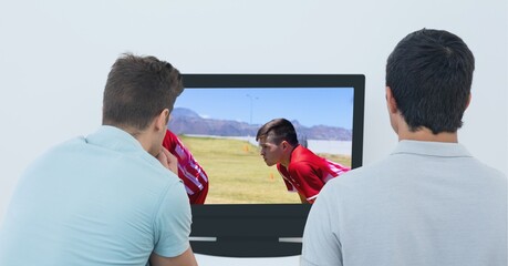 Composition of two male sports fans watching football match on tv