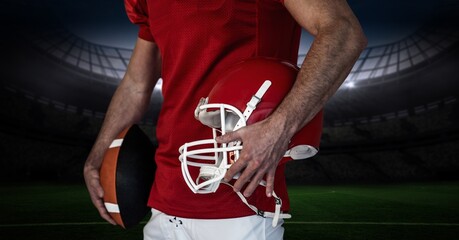 Composition of male american football player holding ball over sports stadium