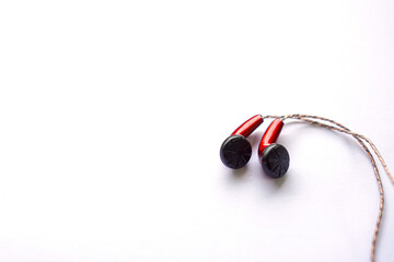 red earphones using wires isolated on white.