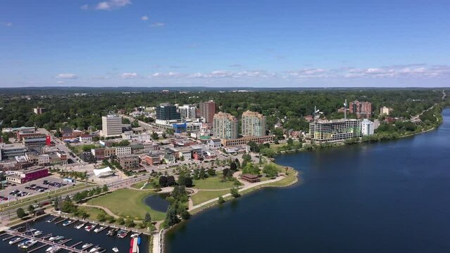 Downtown barrie drone views of Centennial beach summer time green grass blue water  apartment buildings and condos  and park 