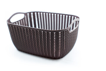 brown plastic basket with woven pattern on a white