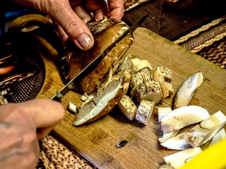 slicing wild mushrooms on a cutting board