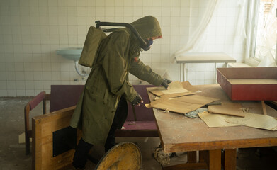 Disaster survivor in a post apocalyptic setting, she is wearing a gas mask and reading document:...