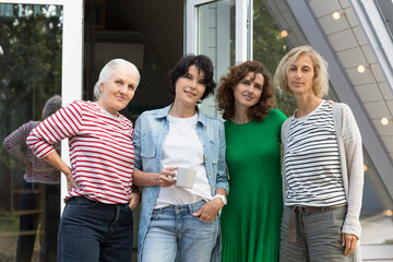 mixed age group women friends having fun together  outdoor. healthy lifestyle. diverse friendship. elderly woman along with adult daughters near her home