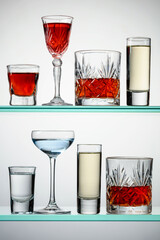 Various alcoholic drinks on glass shelves.