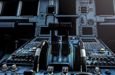 Airbus A320 Cockpit, image of the center pedestal with trim wheels and thrust levers.  - obrazy, fototapety, plakaty