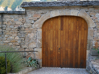 Wooden Door building entrance closed with arch on street medieaval rustic town