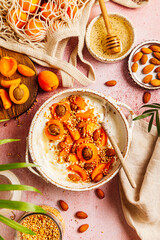 Healthy breakfast bowl with cottage cheese, apricots, almond, quinoa and honey.
