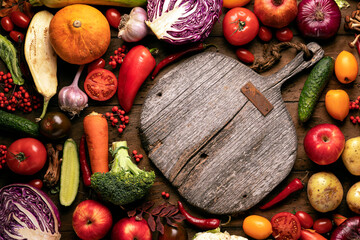 wooden cutting board on the background of vegetables and fruits. Vintage flat lay still life